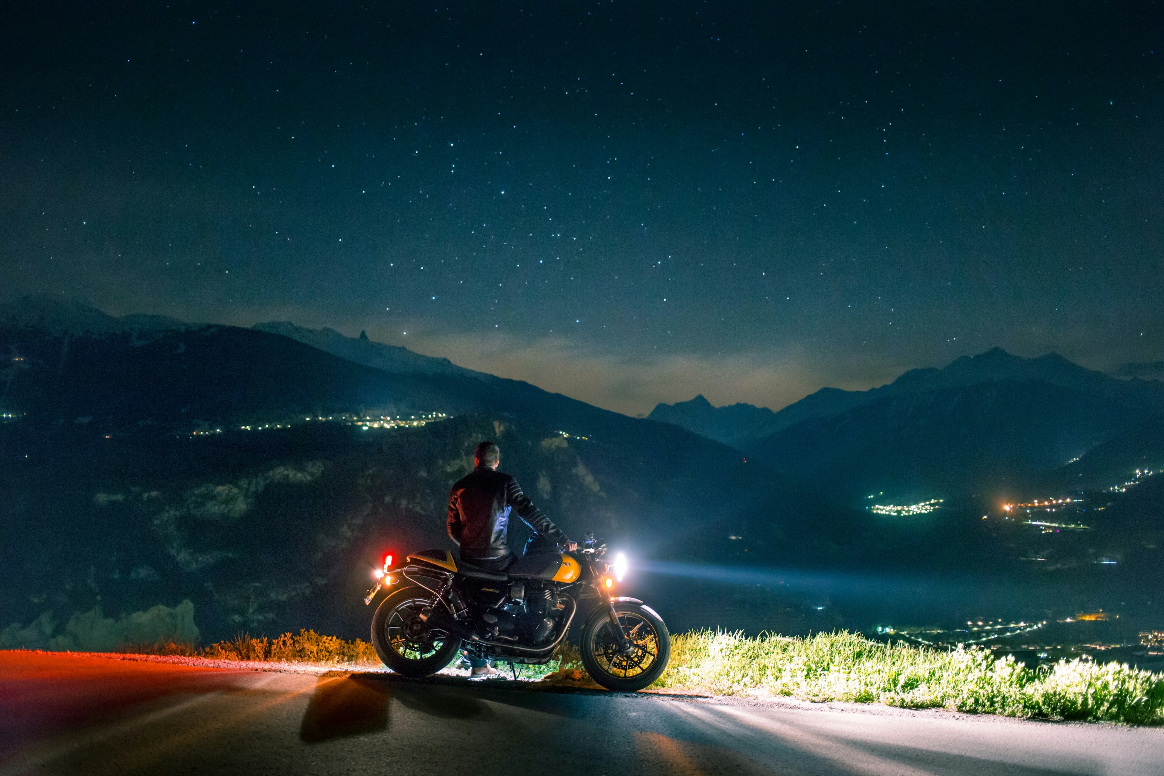 A rider at a viewpoint at night under a sky full of stars