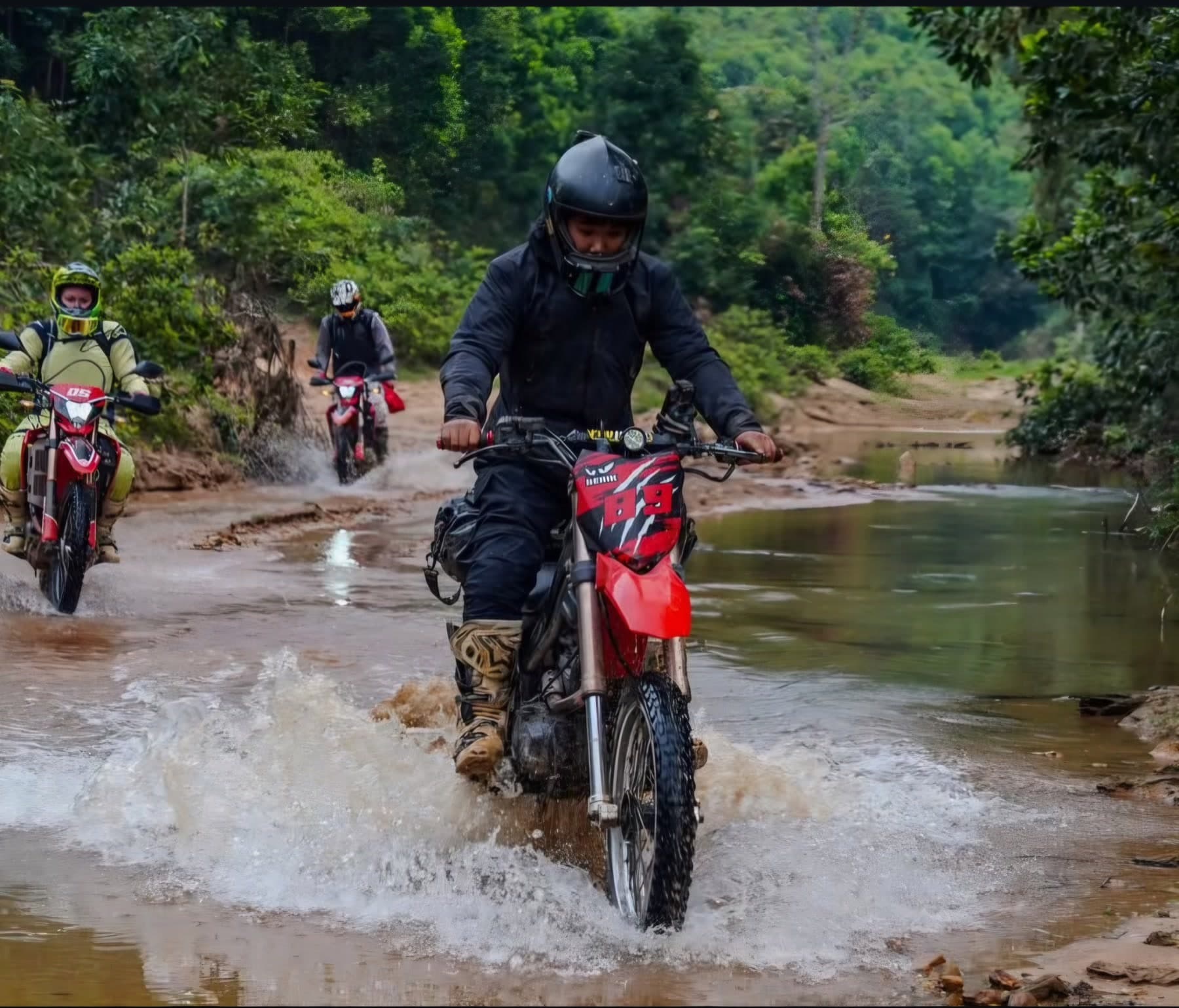 Off-road riders splashing through a stream crossing